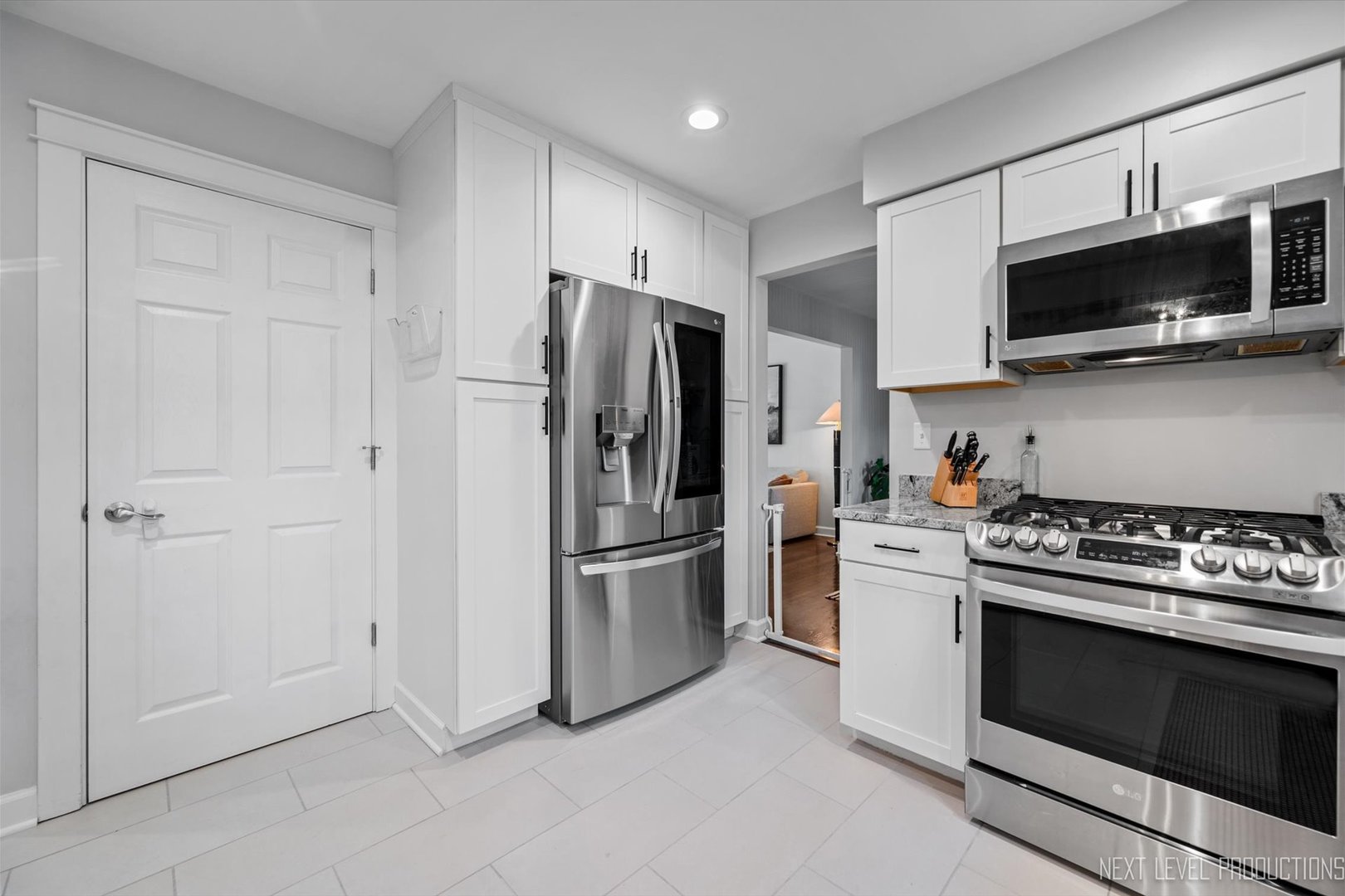 413 Cheever Avenue Geneva, IL 60134 - Photo 13 of 30 a kitchen with stainless steel appliances and white cabinets