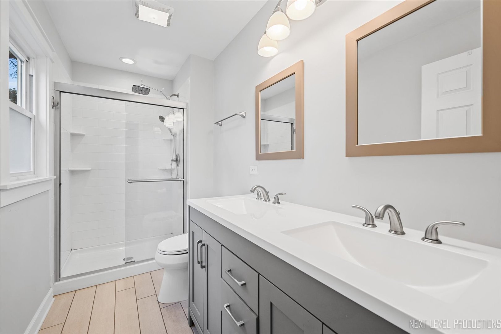 413 Cheever Avenue Geneva, IL 60134 - Photo 21 of 30 a bathroom with a sink toilet double vanity and shower