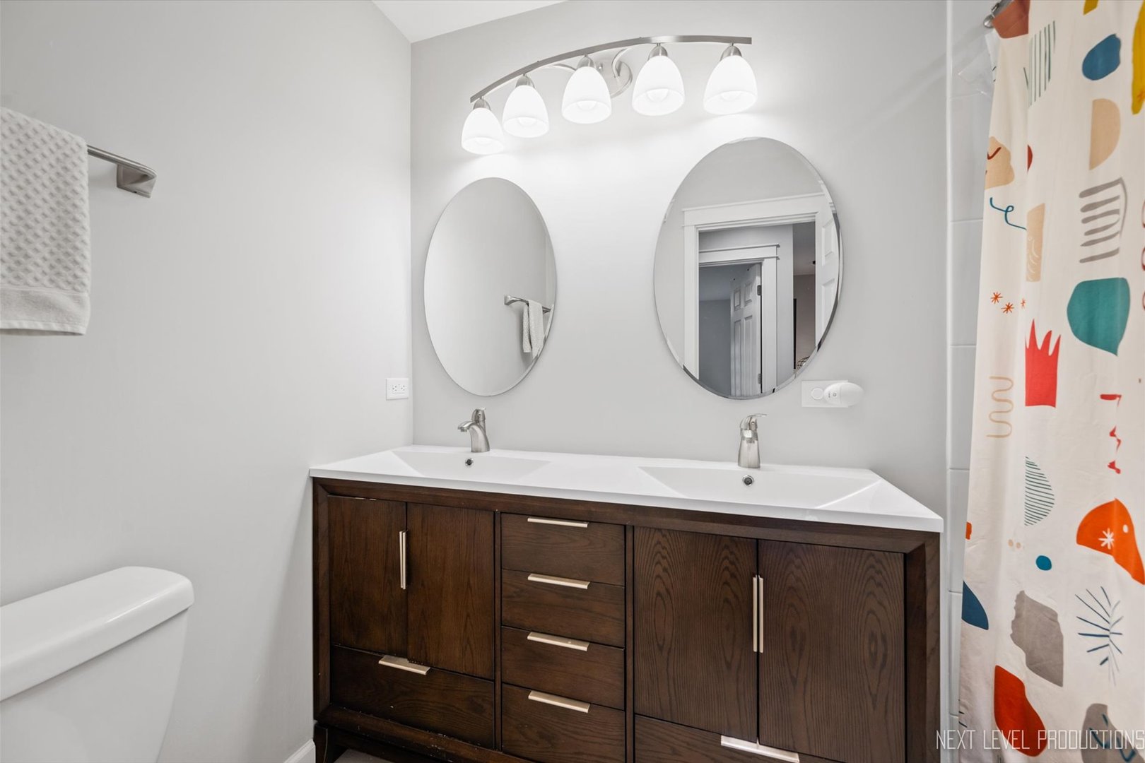 413 Cheever Avenue Geneva, IL 60134 - Photo 24 of 30 a bathroom with a double vanity sink and a mirror
