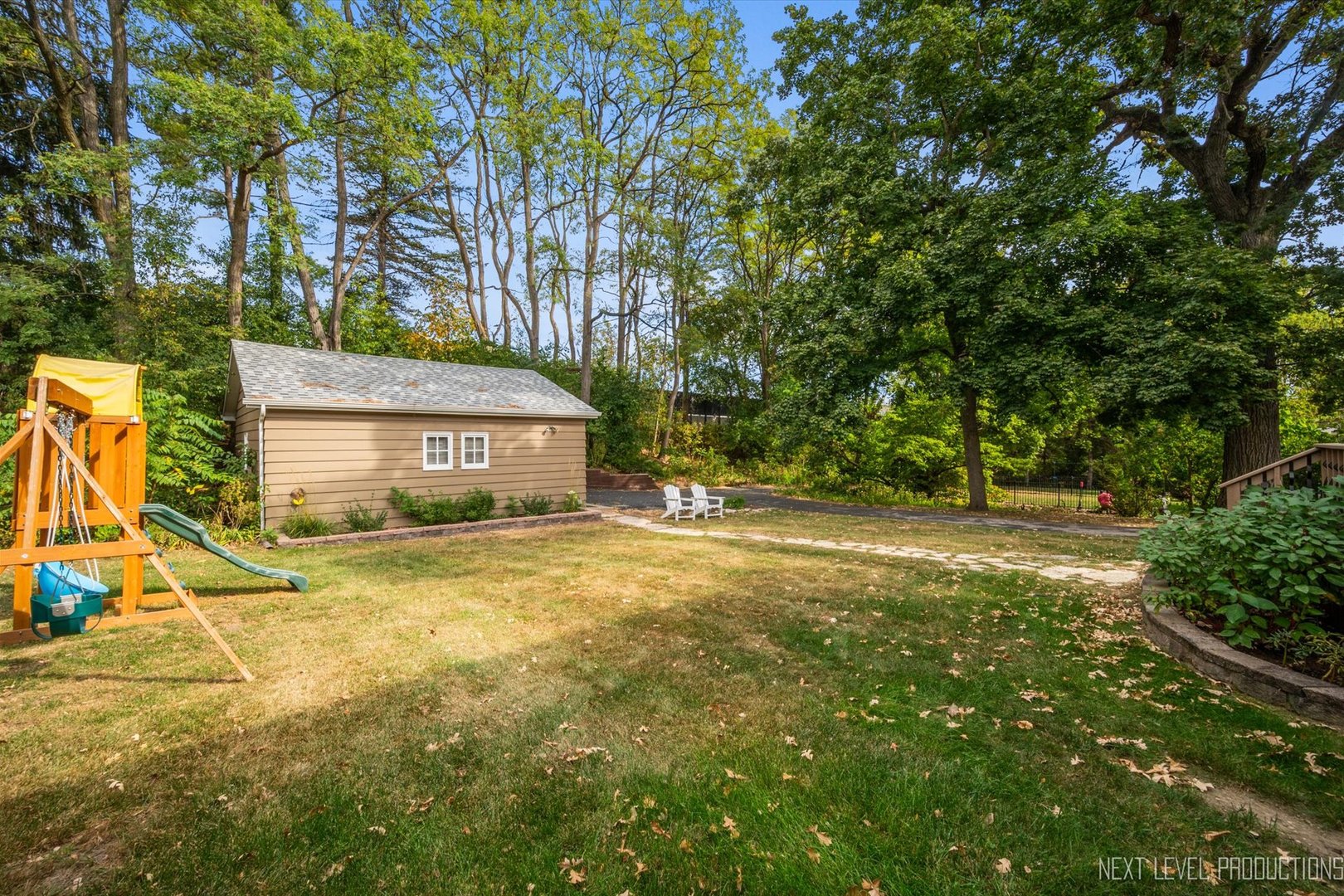 413 Cheever Avenue Geneva, IL 60134 - Photo 29 of 30 a yellow house with trees in front of it