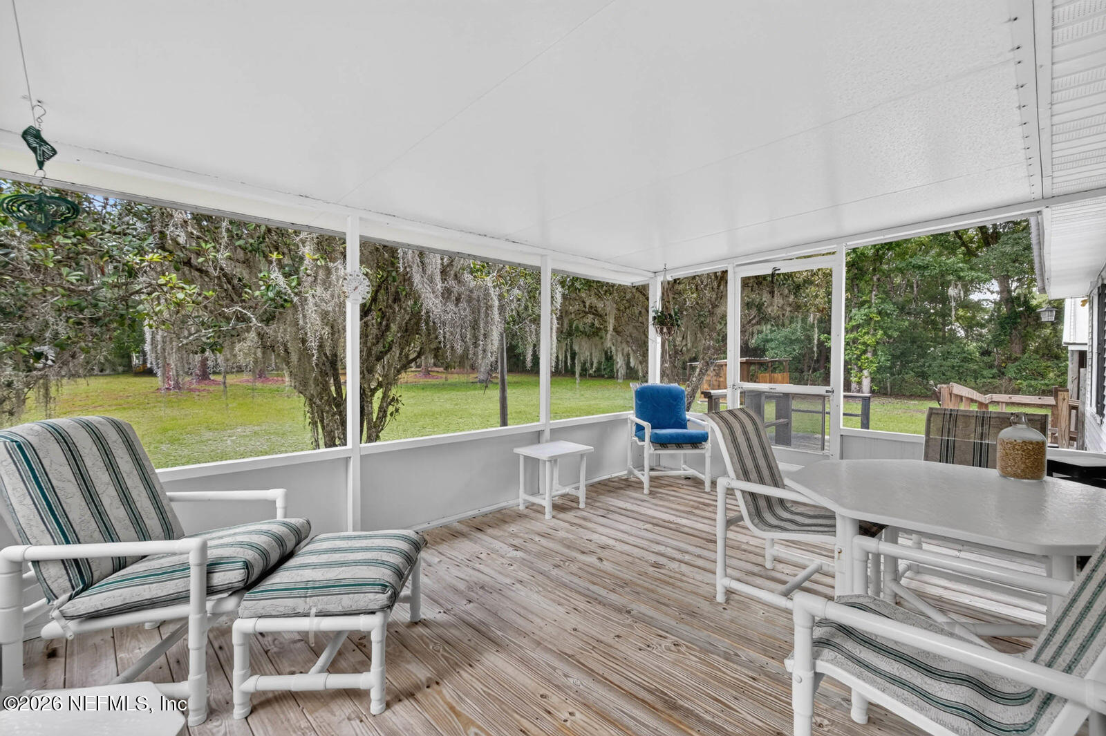 1950 Lightsey Road St. Augustine, FL 32084 - Photo 27 of 57 a view of a patio with a table chairs and a floor to ceiling window