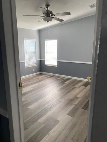 a view of room with window and ceiling fan