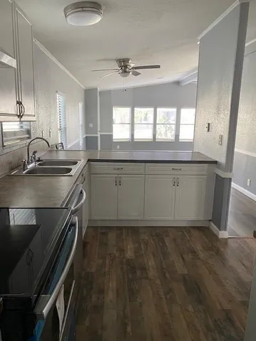 a kitchen with a sink stove and cabinets
