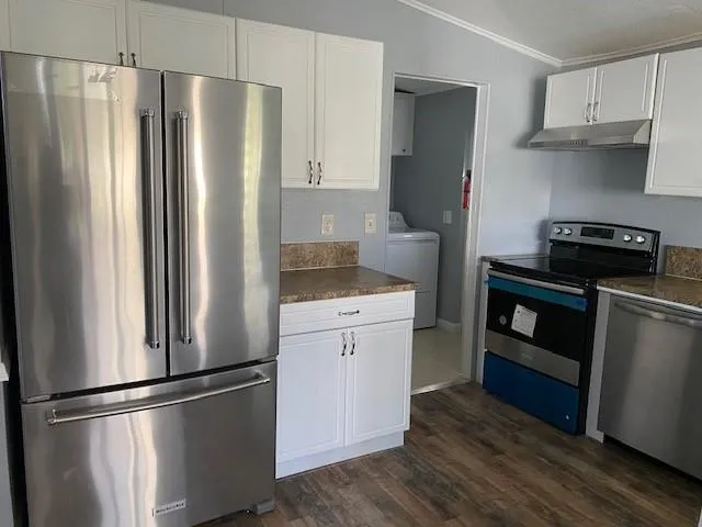 a kitchen with stainless steel appliances a refrigerator stove and sink
