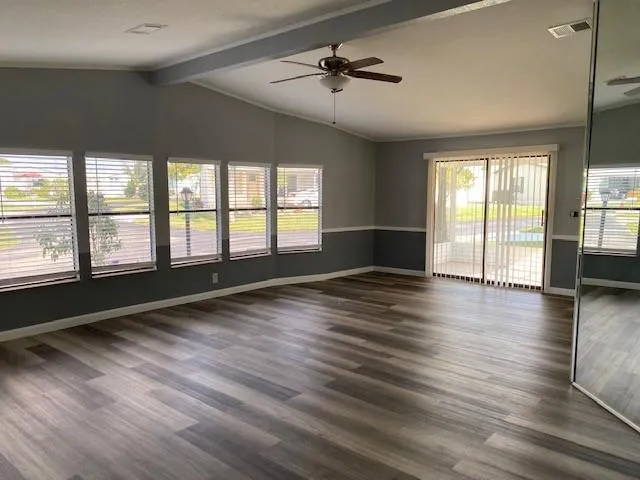 wooden floor in an empty room with a window