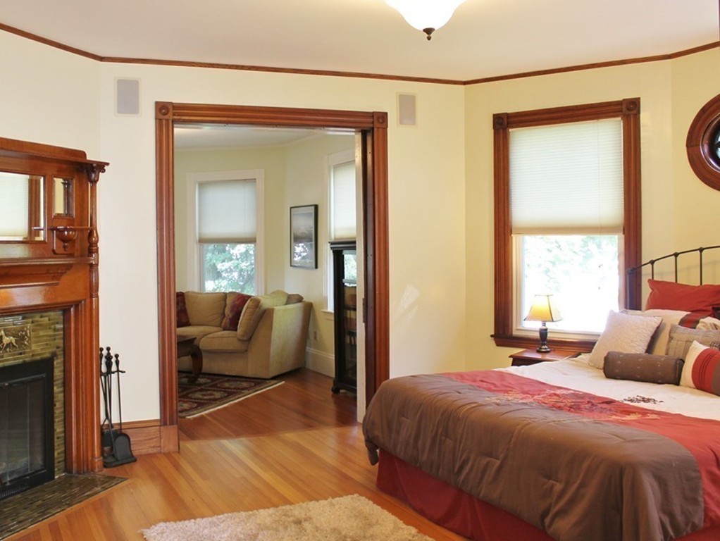 166 Chestnut Street Cambridge, MA 02139 - Photo 12 of 30 a bedroom with a bed and a mirror