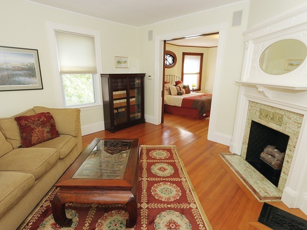 166 Chestnut Street Cambridge, MA 02139 - Photo 13 of 30 a living room with furniture and a fireplace