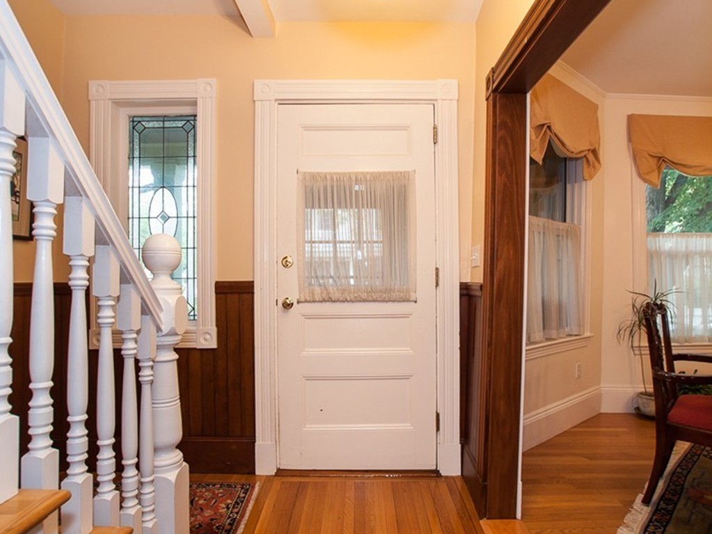 166 Chestnut Street Cambridge, MA 02139 - Photo 2 of 30 a view of a hallway with wooden floor and staircase