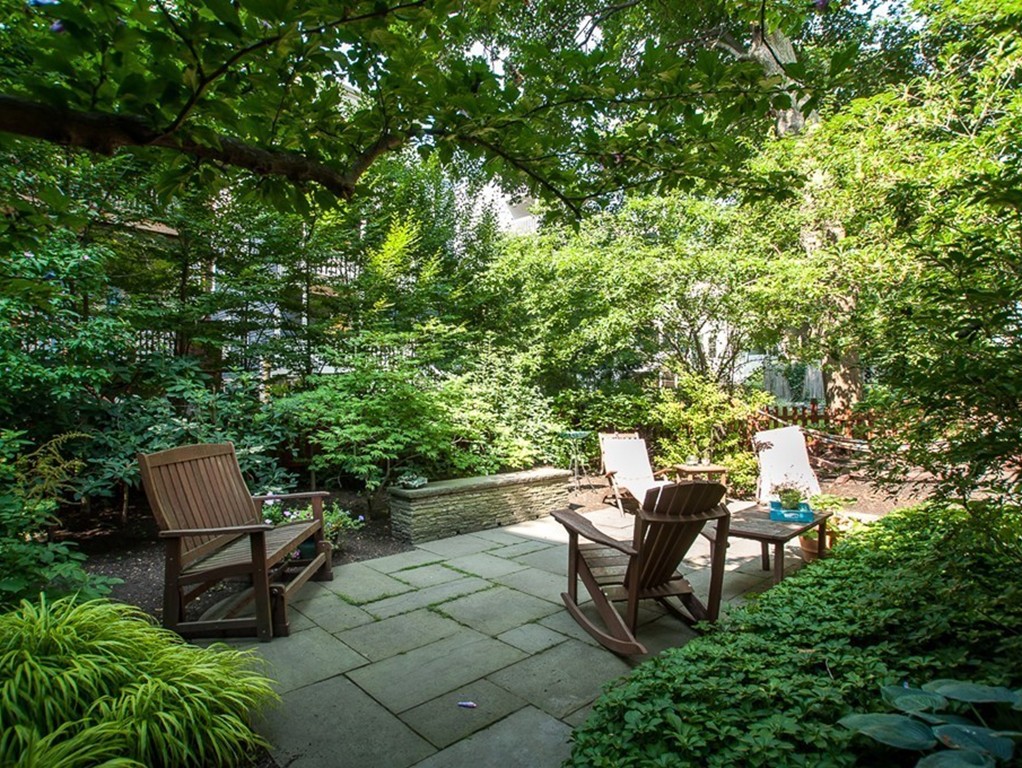 166 Chestnut Street Cambridge, MA 02139 - Photo 29 of 30 a backyard of a house with table and chairs