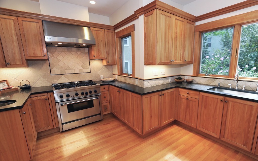 166 Chestnut Street Cambridge, MA 02139 - Photo 5 of 30 a kitchen with stainless steel appliances granite countertop a stove a sink and a microwave
