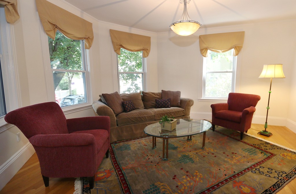 166 Chestnut Street Cambridge, MA 02139 - Photo 7 of 30 a living room with furniture a lamp a window and a chandelier