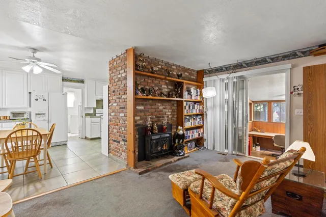 a living room with furniture a ceiling fan and a window