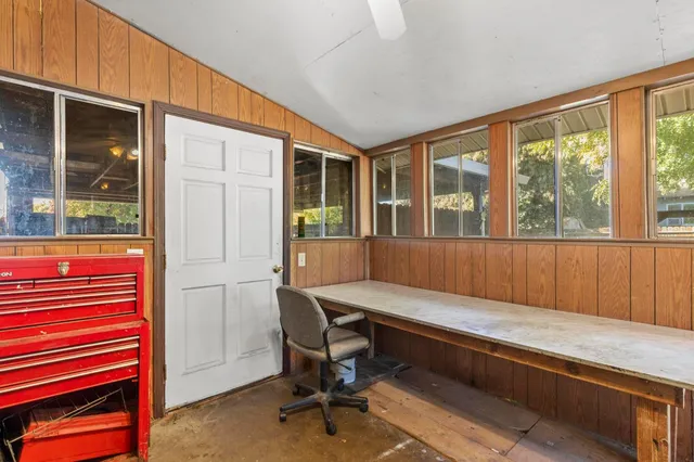 a view of a workspace with furniture and a window