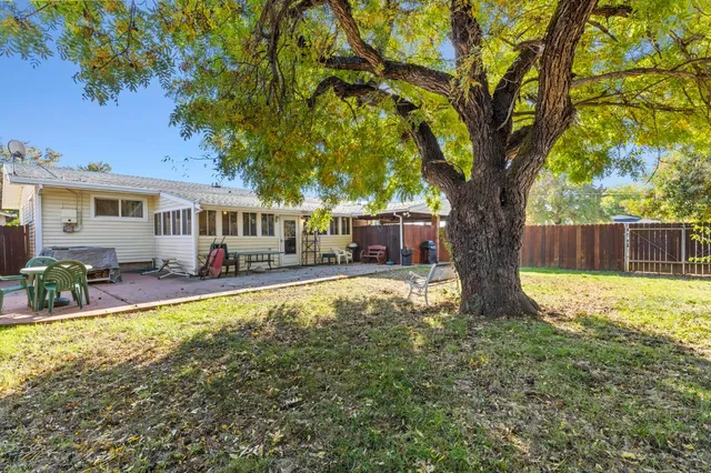 a view of a house with swimming pool and a chairs