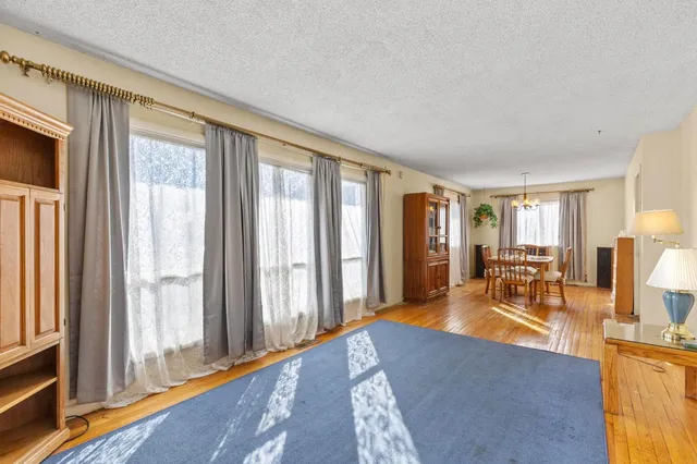 a living room with furniture and large windows