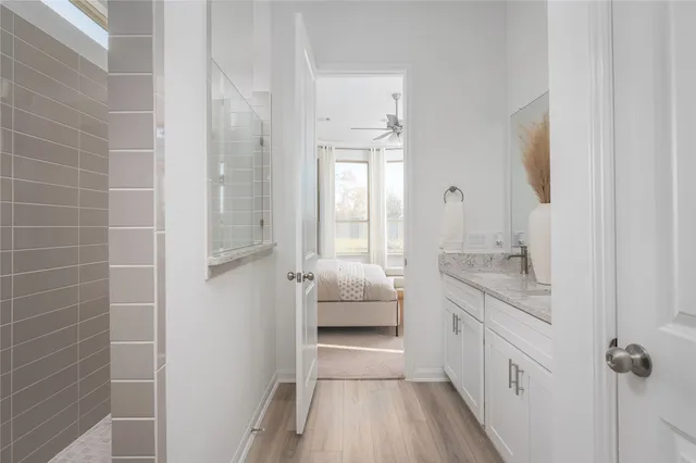 a bathroom with a granite countertop sink a toilet and shower
