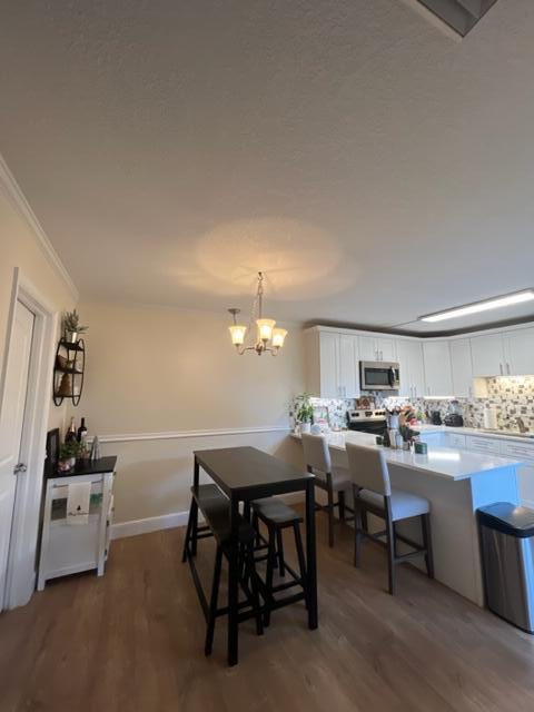 3900 County Line Road, Unit 16A Tequesta, FL 33469 - Photo 12 of 27 a view of a dining room with furniture and chandelier