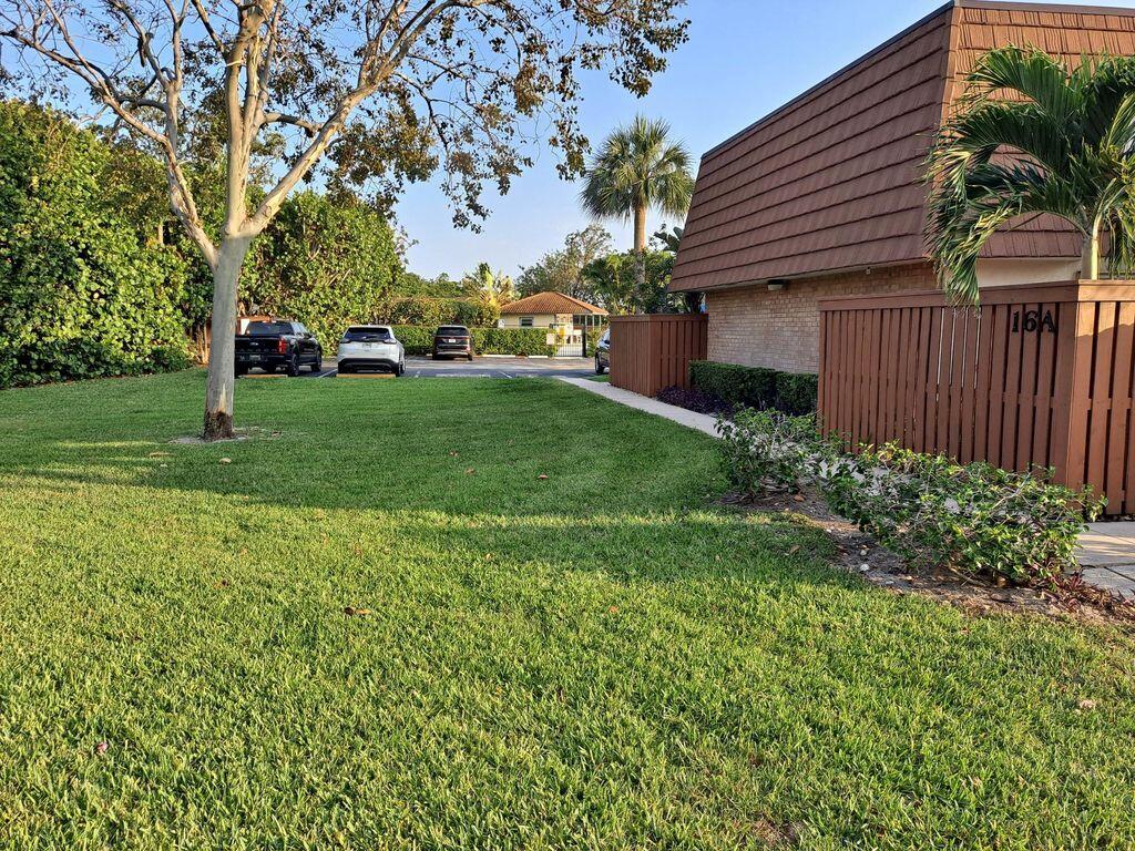 3900 County Line Road, Unit 16A Tequesta, FL 33469 - Photo 2 of 27 a view of a yard with a house