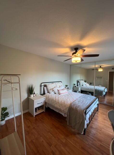 3900 County Line Road, Unit 16A Tequesta, FL 33469 - Photo 21 of 27 a bedroom with a bed and wooden floor