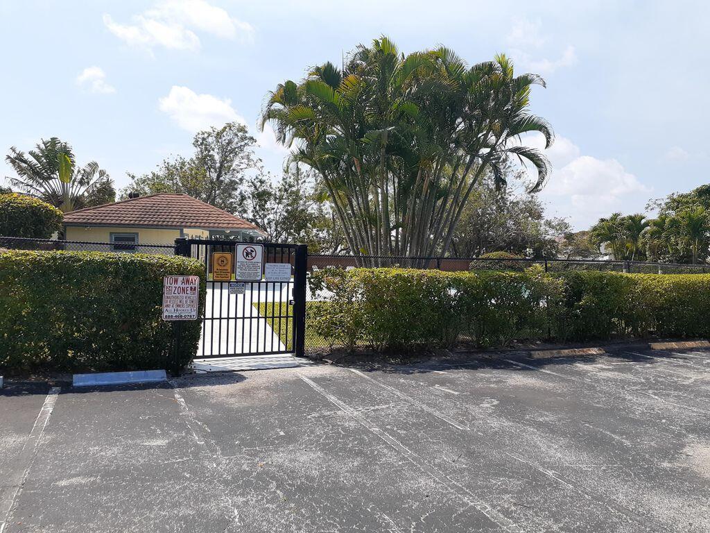 3900 County Line Road, Unit 16A Tequesta, FL 33469 - Photo 25 of 27 a front view of a house with a garden