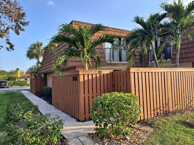 3900 County Line Road, Unit 16A Tequesta, FL 33469 - Photo 27 of 27 a view of a house with a small yard and plants