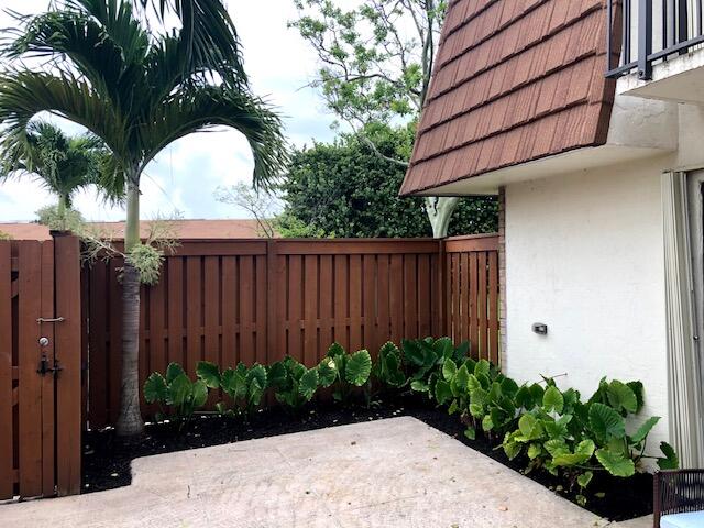3900 County Line Road, Unit 16A Tequesta, FL 33469 - Photo 3 of 27 a view of a backyard with potted plants
