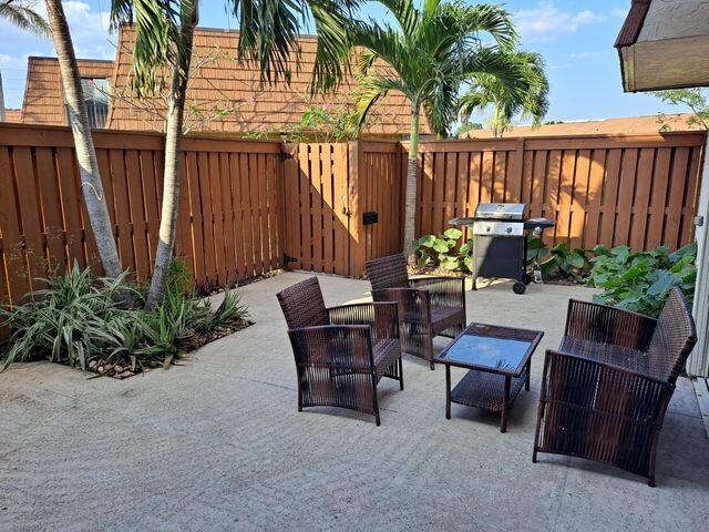 3900 County Line Road, Unit 16A Tequesta, FL 33469 - Photo 5 of 27 a view of a chairs and tables in the patio