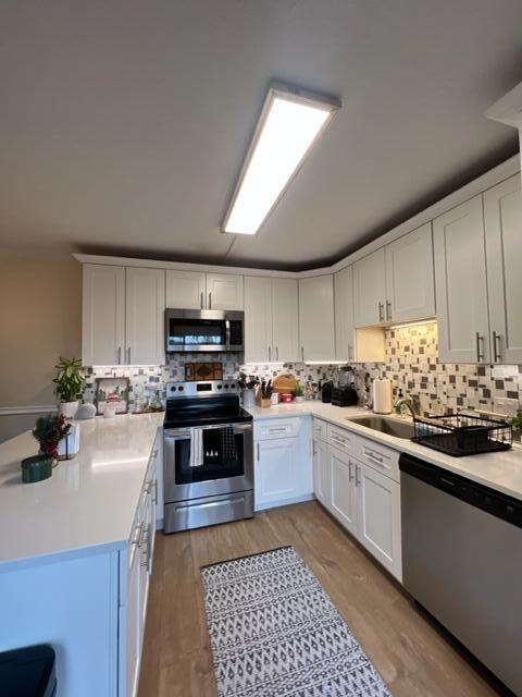 3900 County Line Road, Unit 16A Tequesta, FL 33469 - Photo 9 of 27 a kitchen with stainless steel appliances granite countertop a stove sink and cabinets