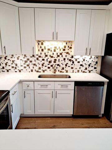 3900 County Line Road, Unit 16A Tequesta, FL 33469 - Photo 10 of 27 a kitchen with white cabinets and sink