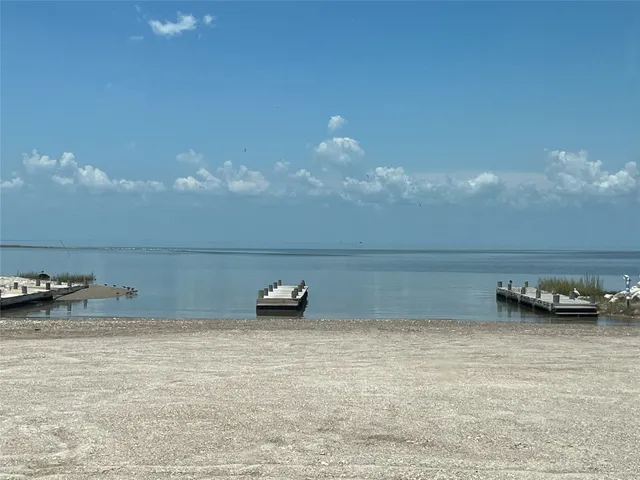 a view of a yard with cars parked