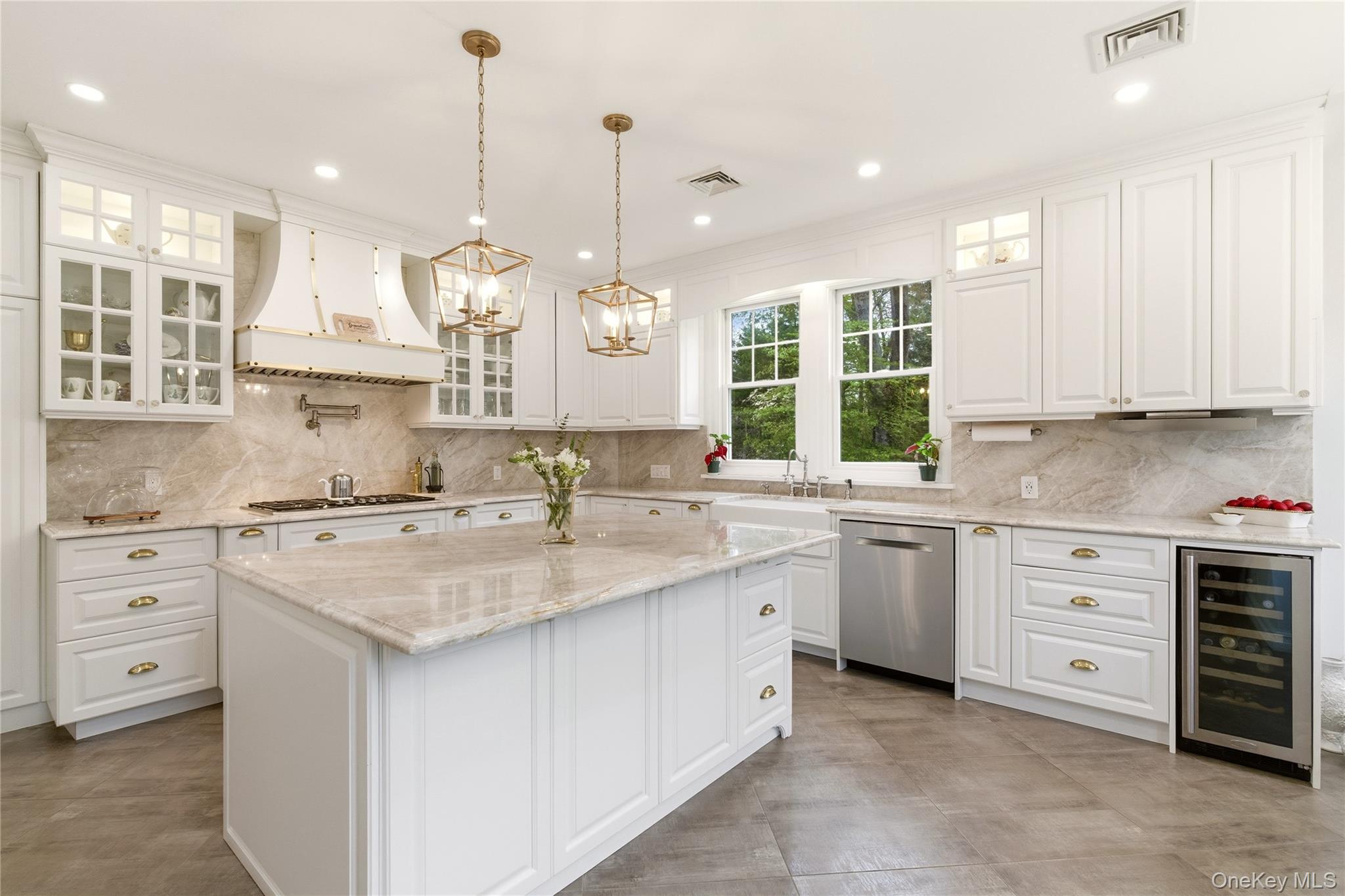 89 Duck Pond Road Glen Cove, NY 11542 - Photo 13 of 37 a kitchen with kitchen island granite countertop a sink stove and cabinets
