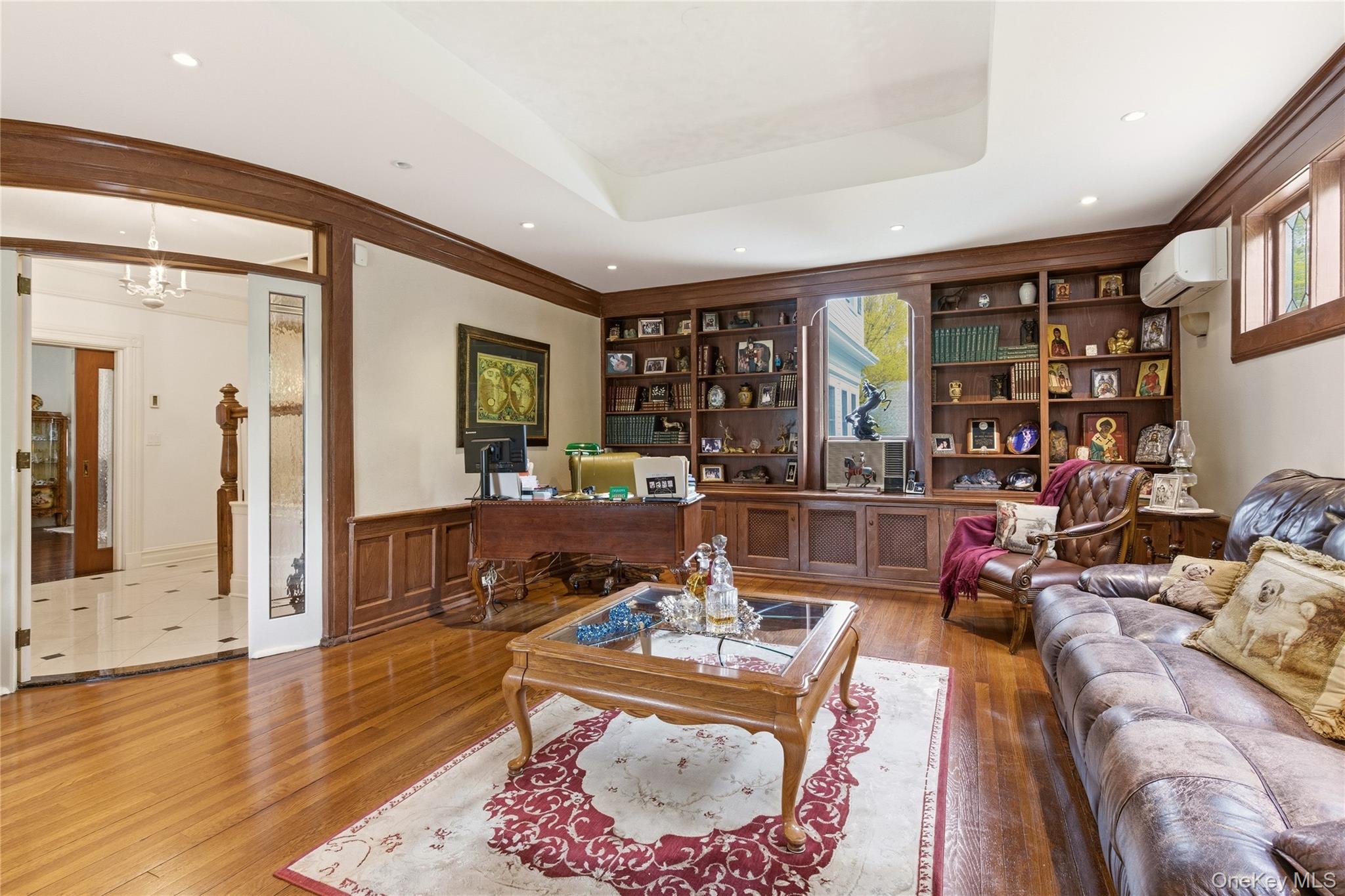 89 Duck Pond Road Glen Cove, NY 11542 - Photo 18 of 37 a living room with fireplace furniture and a wooden floor
