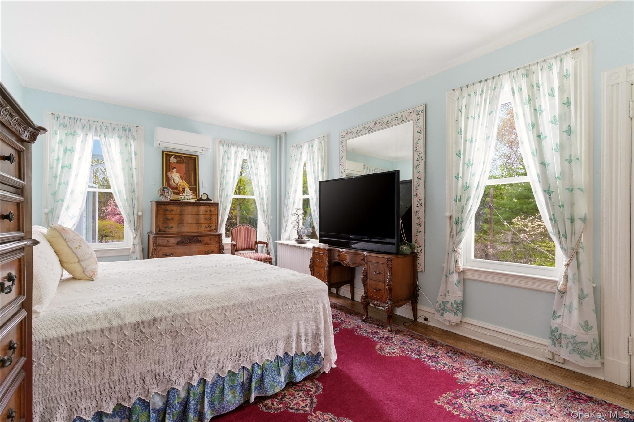 89 Duck Pond Road Glen Cove, NY 11542 - Photo 24 of 37 a bedroom with a bed and a flat screen tv