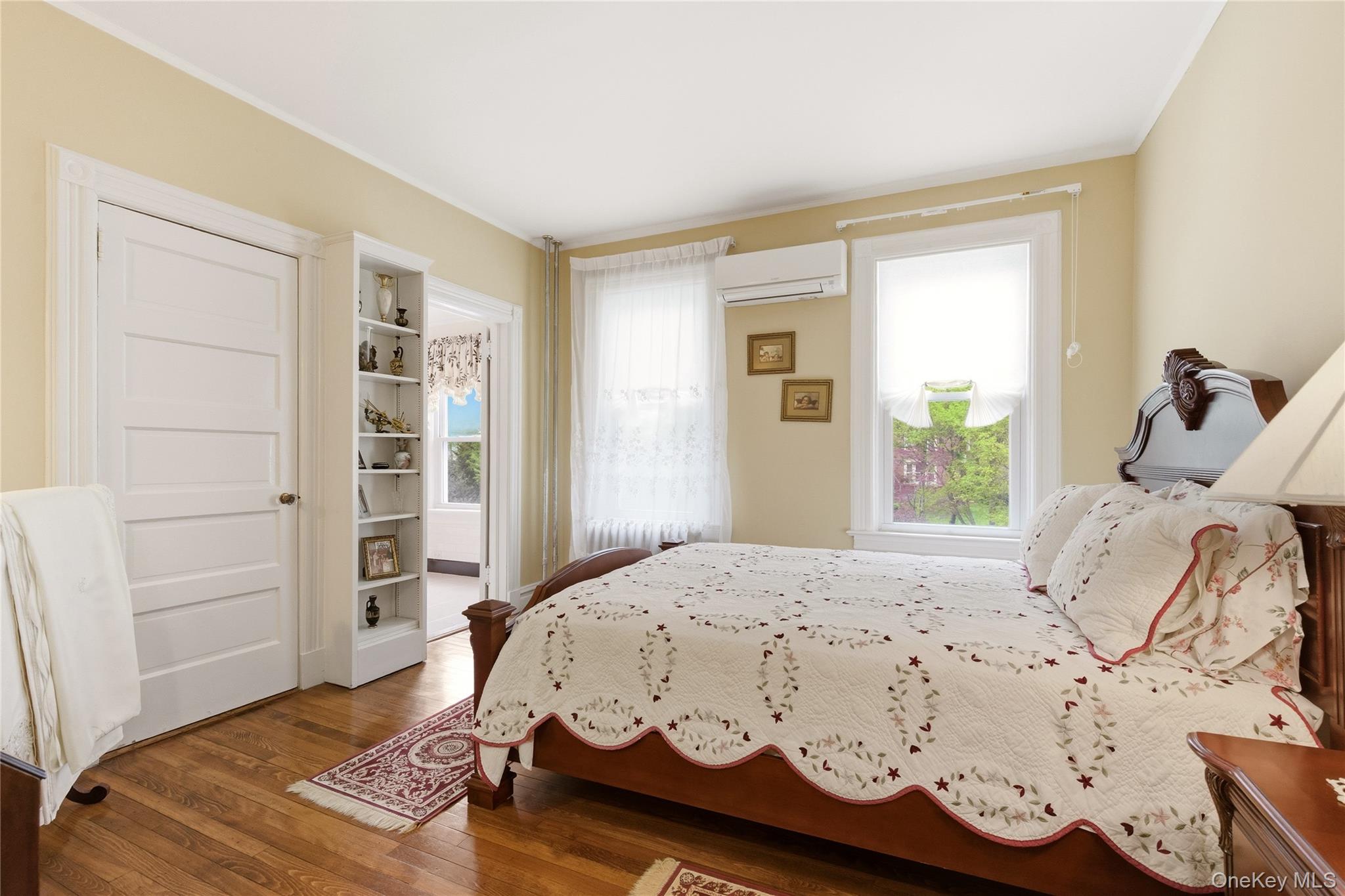 89 Duck Pond Road Glen Cove, NY 11542 - Photo 26 of 37 a bedroom with a bed and wooden floor