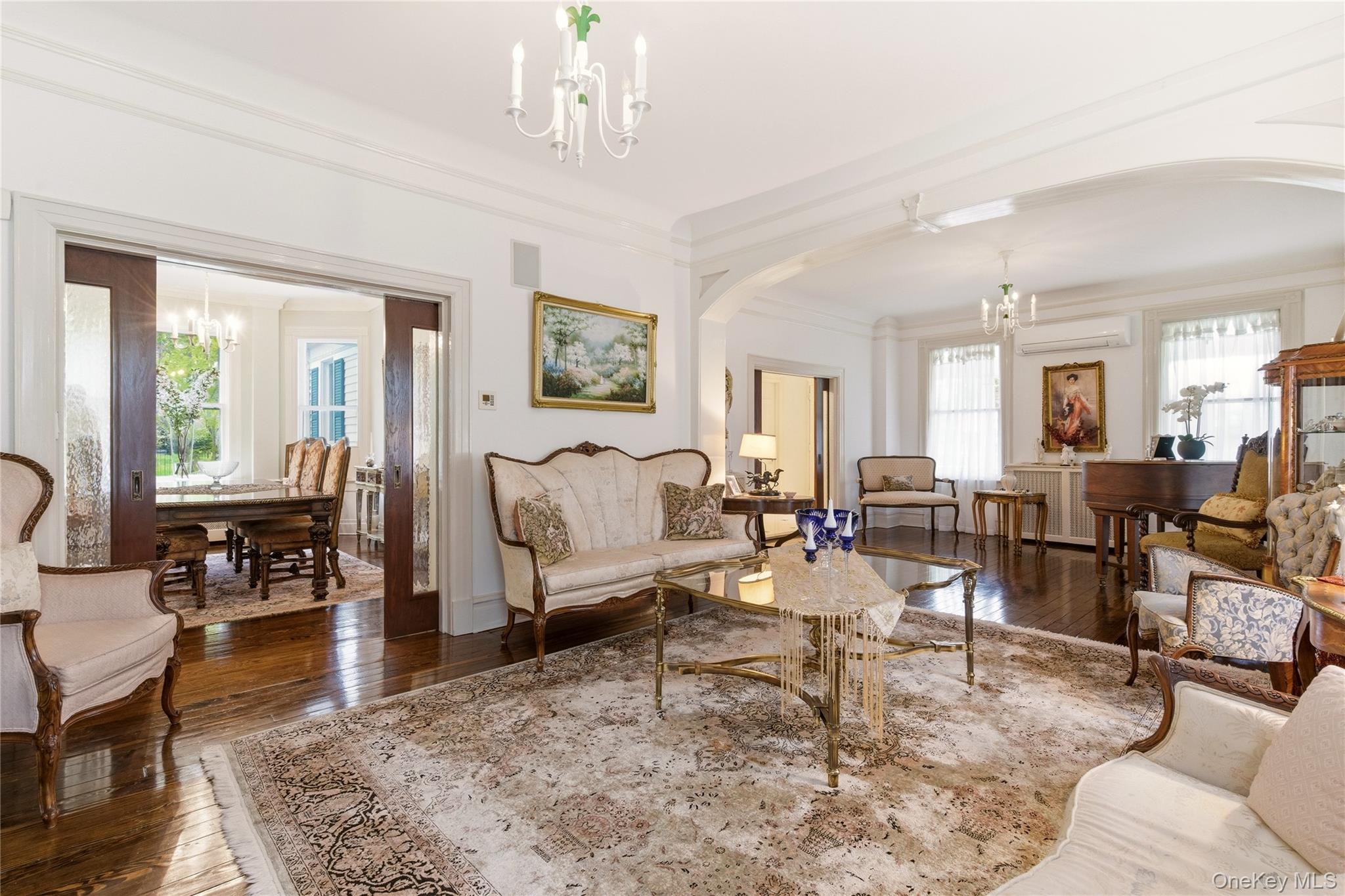 89 Duck Pond Road Glen Cove, NY 11542 - Photo 7 of 37 a living room with lots of furniture and a chandelier