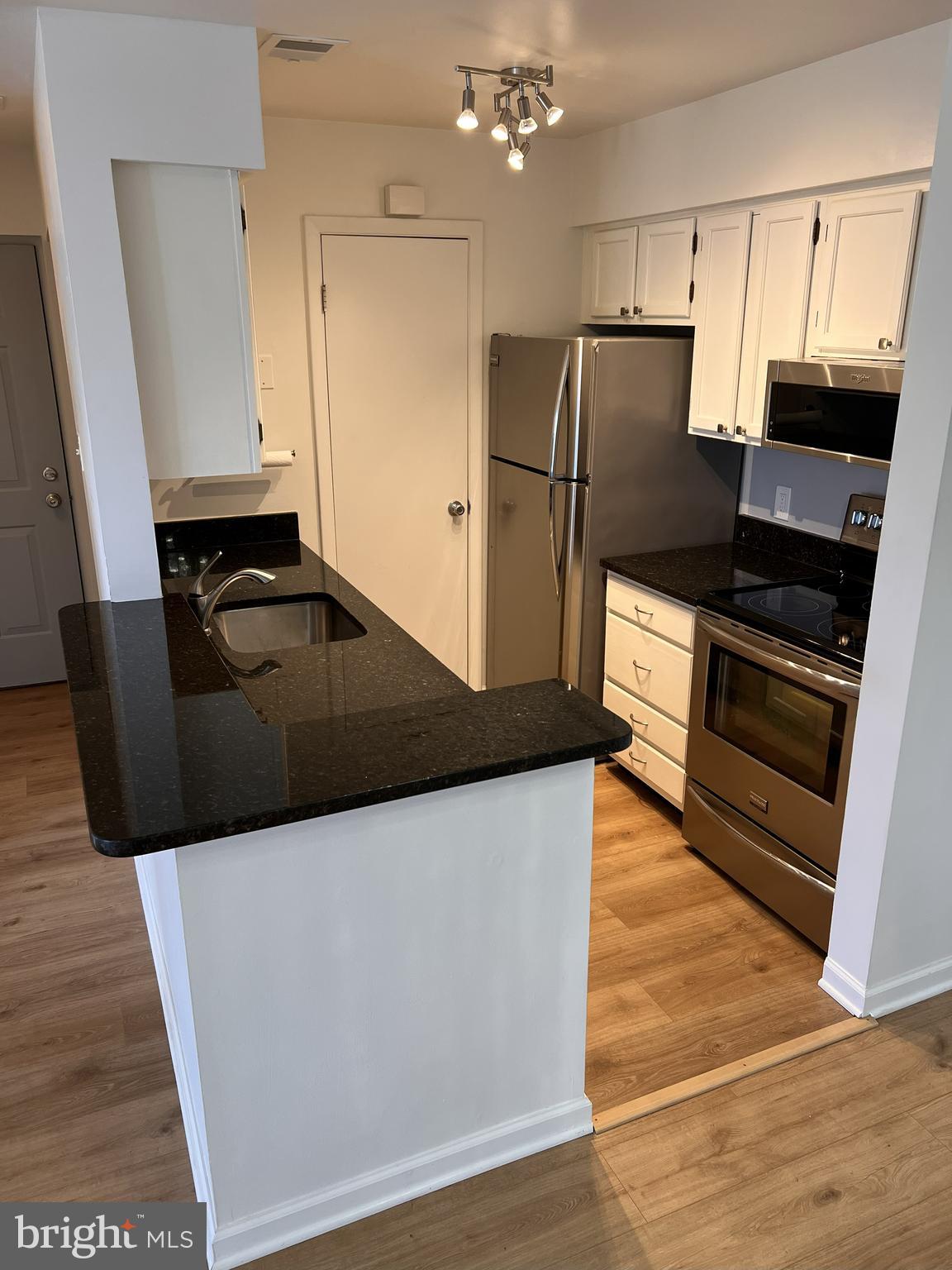 5355 Smooth Meadow Way, Unit 5 Columbia, MD 21044 - Photo 3 of 27 a kitchen with granite countertop a refrigerator and a sink