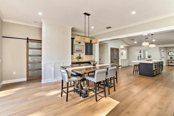 a view of a dining room with furniture and wooden floor