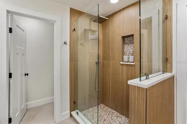 a bathroom with a shower and a sink
