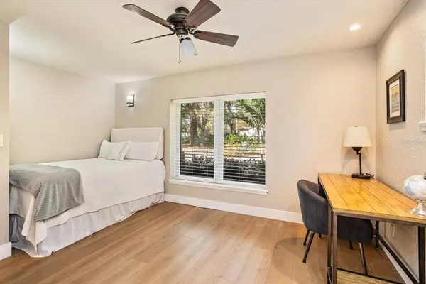 a bedroom with a bed and wooden floor
