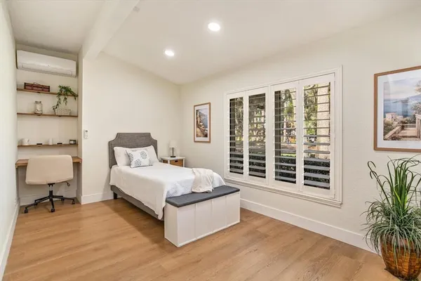 a bedroom with a large bed and a window