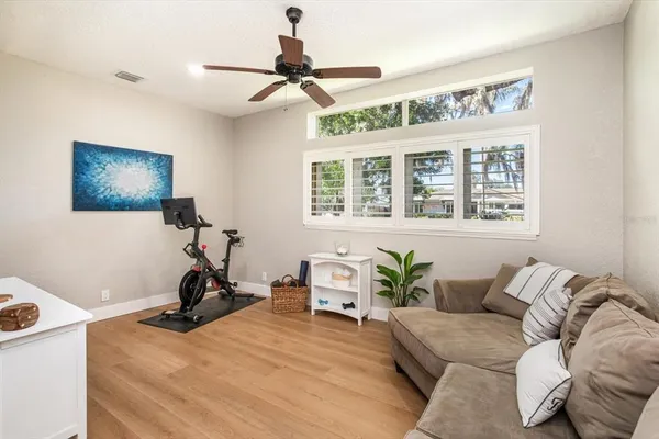 a living room with furniture a flat screen tv and a window