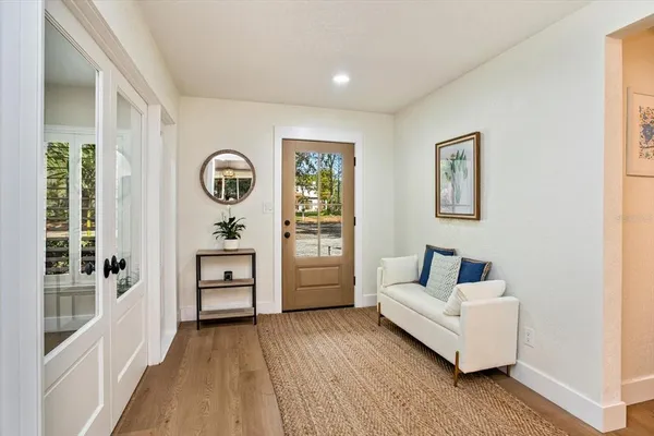a living room with furniture and wooden floor