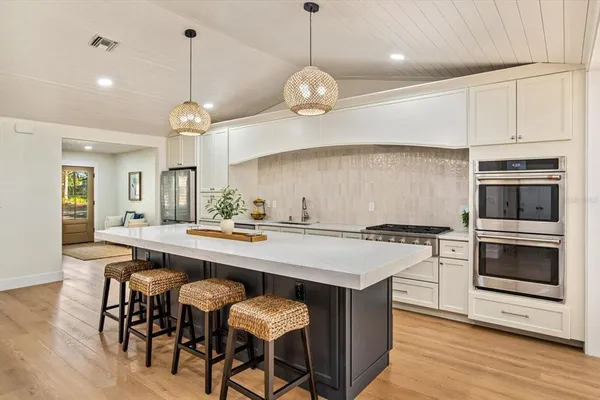 a kitchen with a dining table and chairs