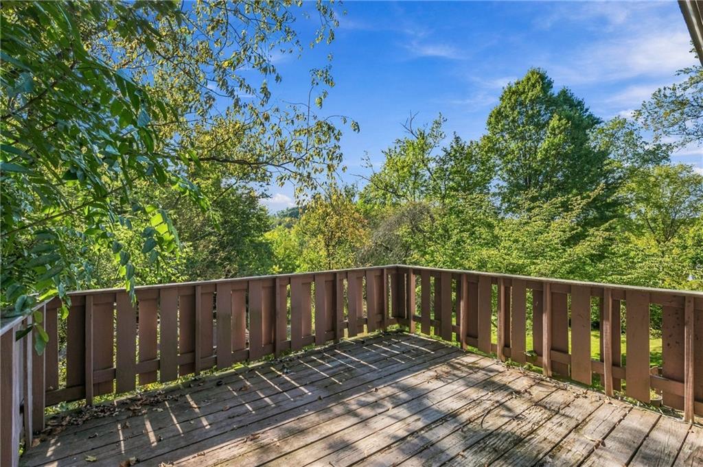 218 Elmore Road Pittsburgh, PA 15221 - Photo 10 of 34 Spacious outdoor deck surrounded by mature trees and greenery.