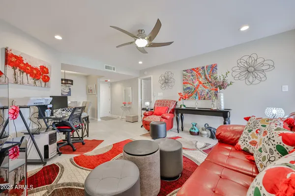 a living room with furniture a flat screen tv and a large window