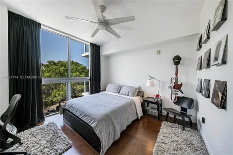 a bedroom with a bed a couch and a window