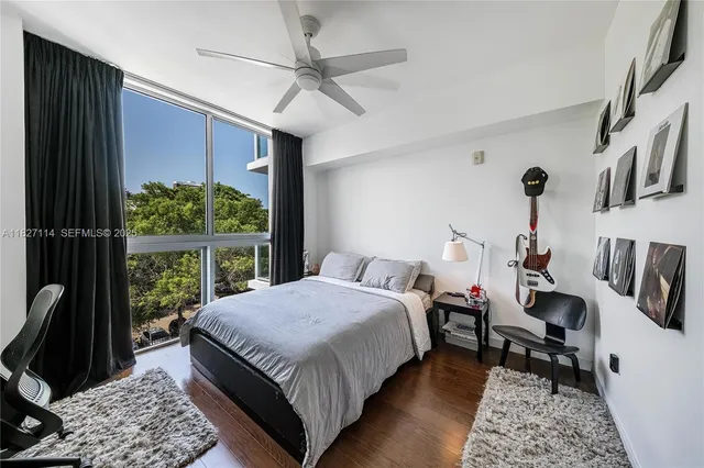 a bedroom with a bed a couch and a window