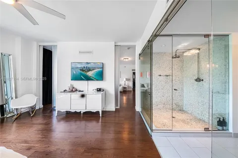 a hallway with a white furniture and floor to ceiling window