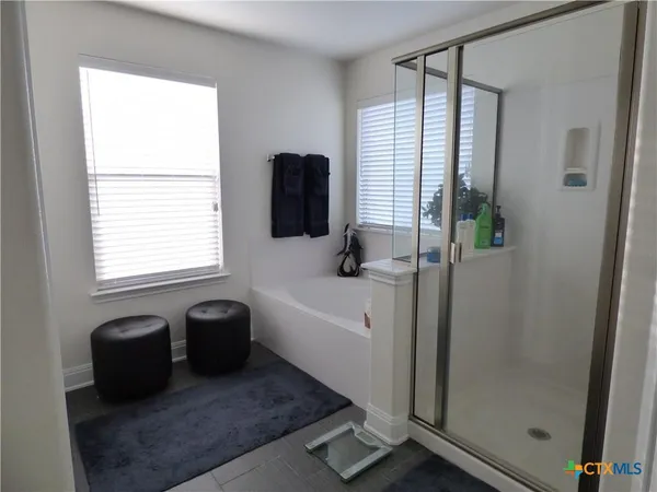 a bathroom with a bathtub and a shower