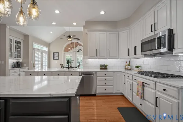 a bathroom with a granite countertop sink a large mirror and a shower